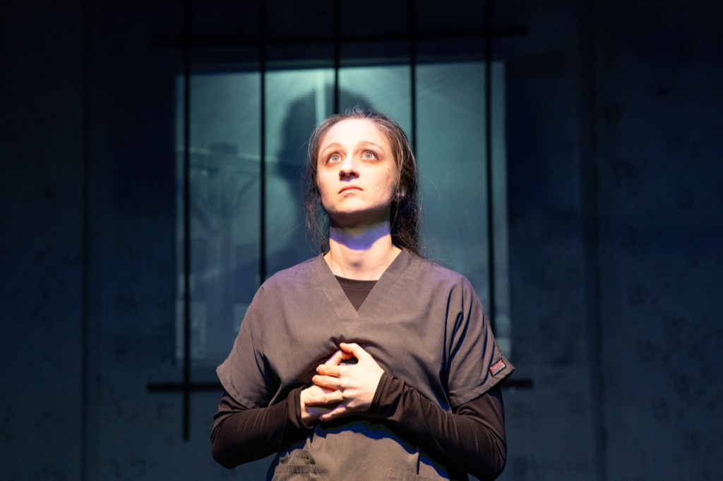 Scene from an Executing Eve stage production.